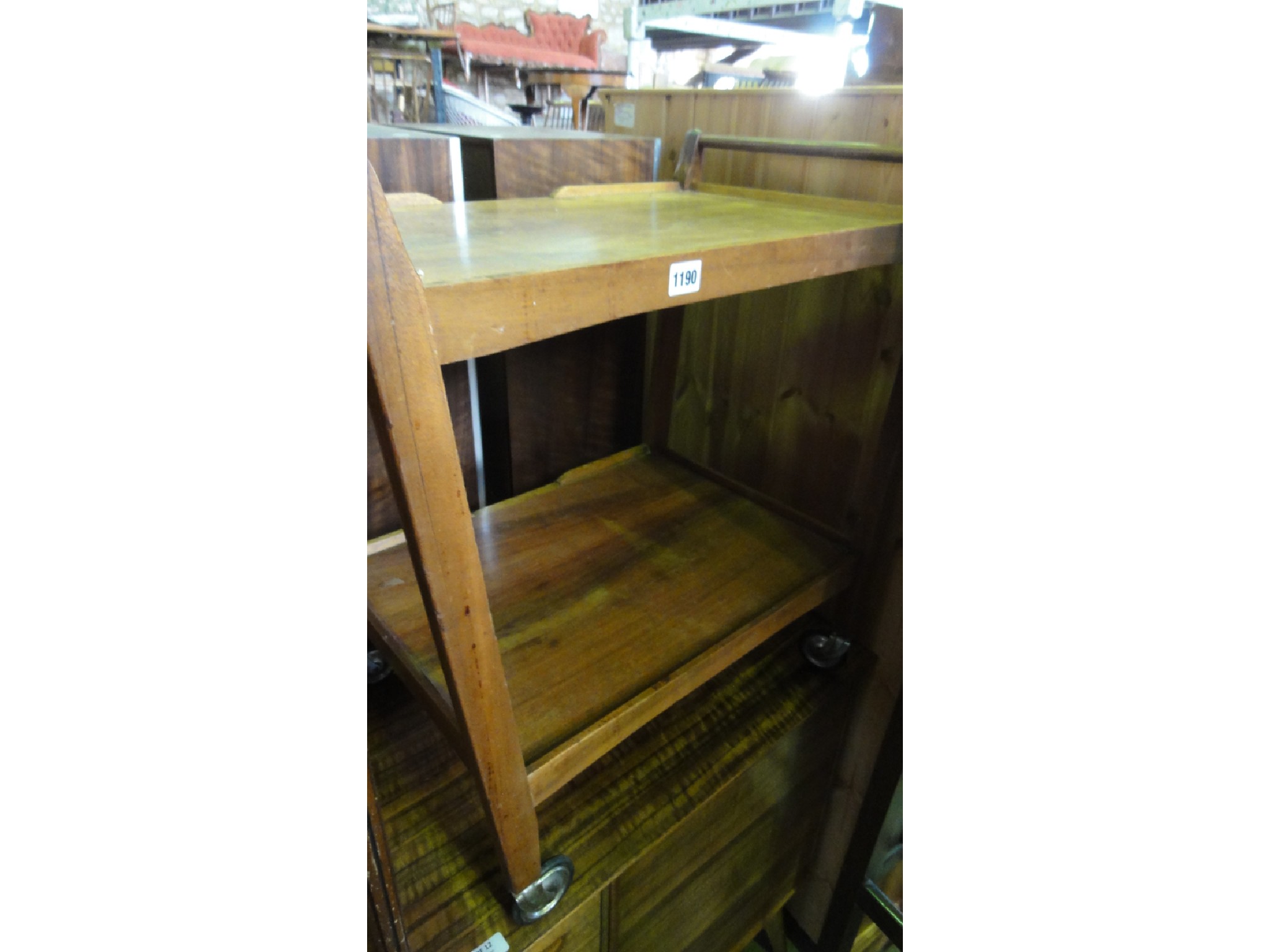 Appraisal: A vintage teak two tier tea trolley with tapered supports