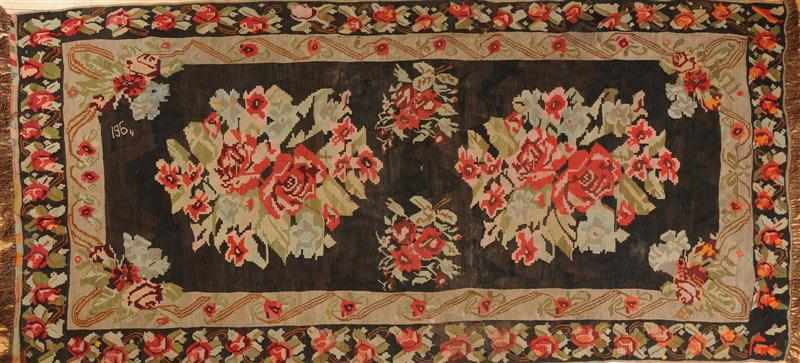 Appraisal: BESSARABIAN BLACK-GROUND RUG Worked with the date and with rosehead