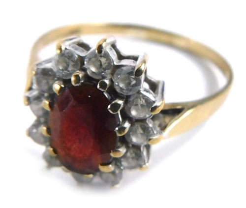 Appraisal: A ct gold cluster ring with central garnet surrounded by