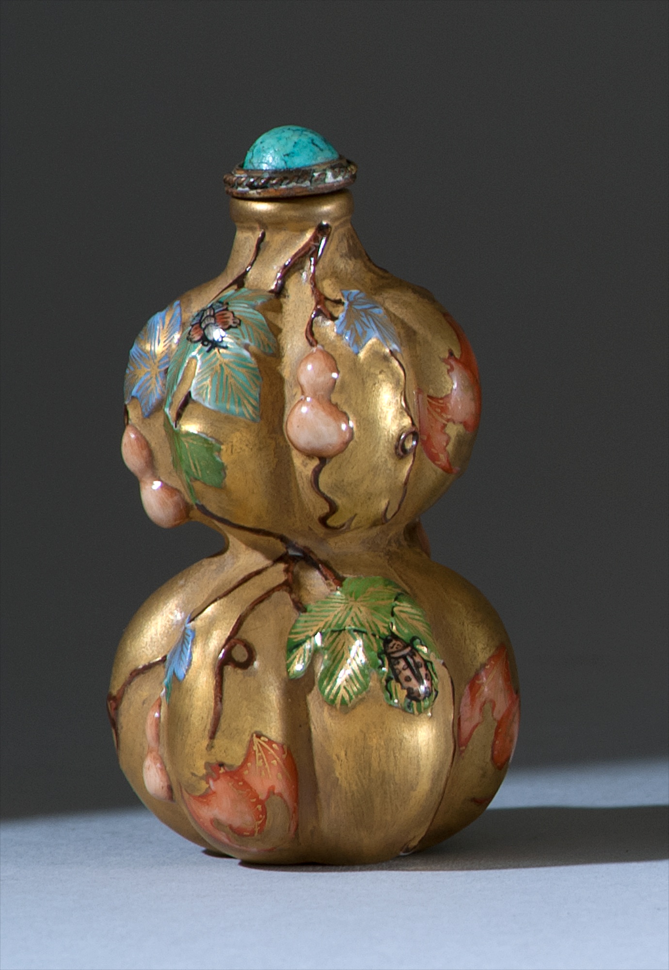 Appraisal: PORCELAIN SNUFF BOTTLE Double gourd form with relief polychrome design