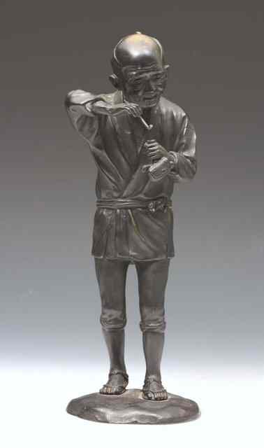 Appraisal: A JAPANESE BRONZE MODEL OF A FIGURE holding a pipe