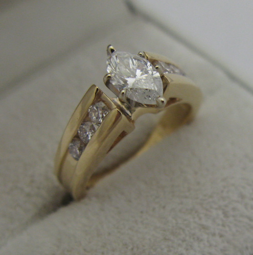 Appraisal: DIAMOND AND K YELLOW GOLD RING centering a marquise-cut diamond