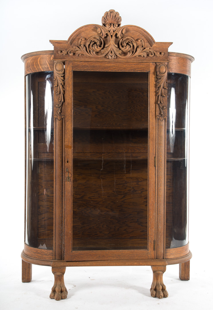 Appraisal: Late Victorian carved oak china cupboard circa shell and foliate