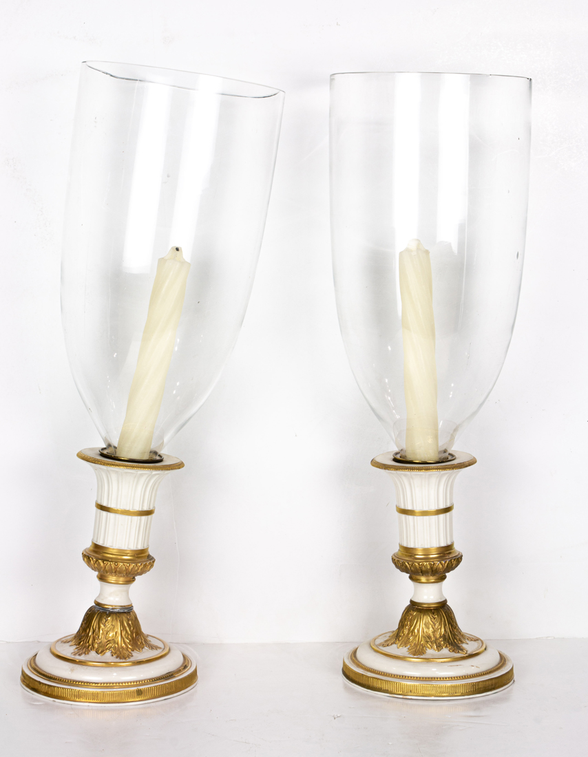 Appraisal: PAIR OF MOTTAHEDEH NEOCLASSICAL STYLE PORCELAIN CANDLESTICKS WITH GLASS HURRICANE