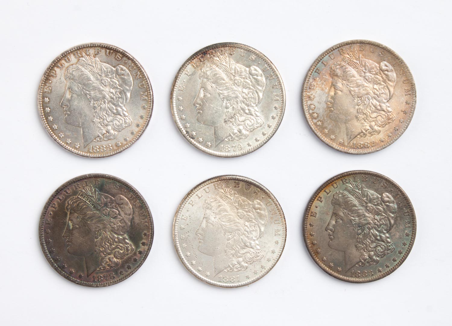 Appraisal: Six U S Morgan type silver dollars - comprising seven