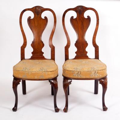 Appraisal: A pair of walnut single chairs with carved shell above