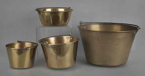 Appraisal: Four brass pots with iron swing handles h dia