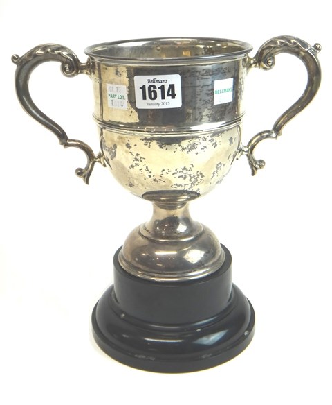 Appraisal: A silver twin handled trophy cup on a domed circular