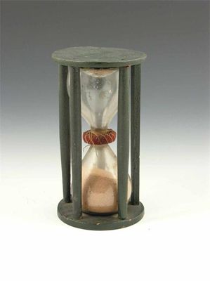 Appraisal: An th century green painted wood hour glass with circular