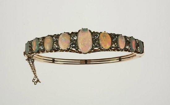 Appraisal: An Edwardian gold triple gate bangle set a central opal