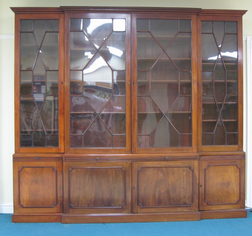 Appraisal: A th Century Georgian style mahogany Breakfront Bookcase the upper