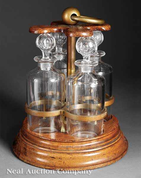 Appraisal: An English Oak and Brass Tantalus c marked Harrison Patent