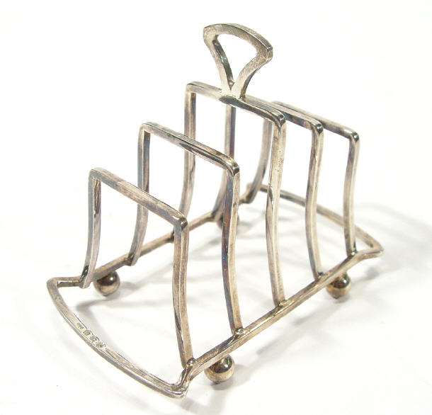 Appraisal: Silver four slice toast rack Birmingham cm in length