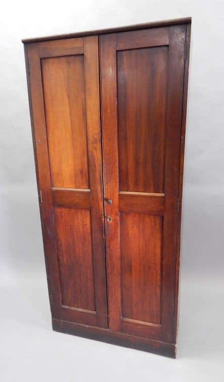 Appraisal: A mahogany school type cupboard with two panelled doors cm