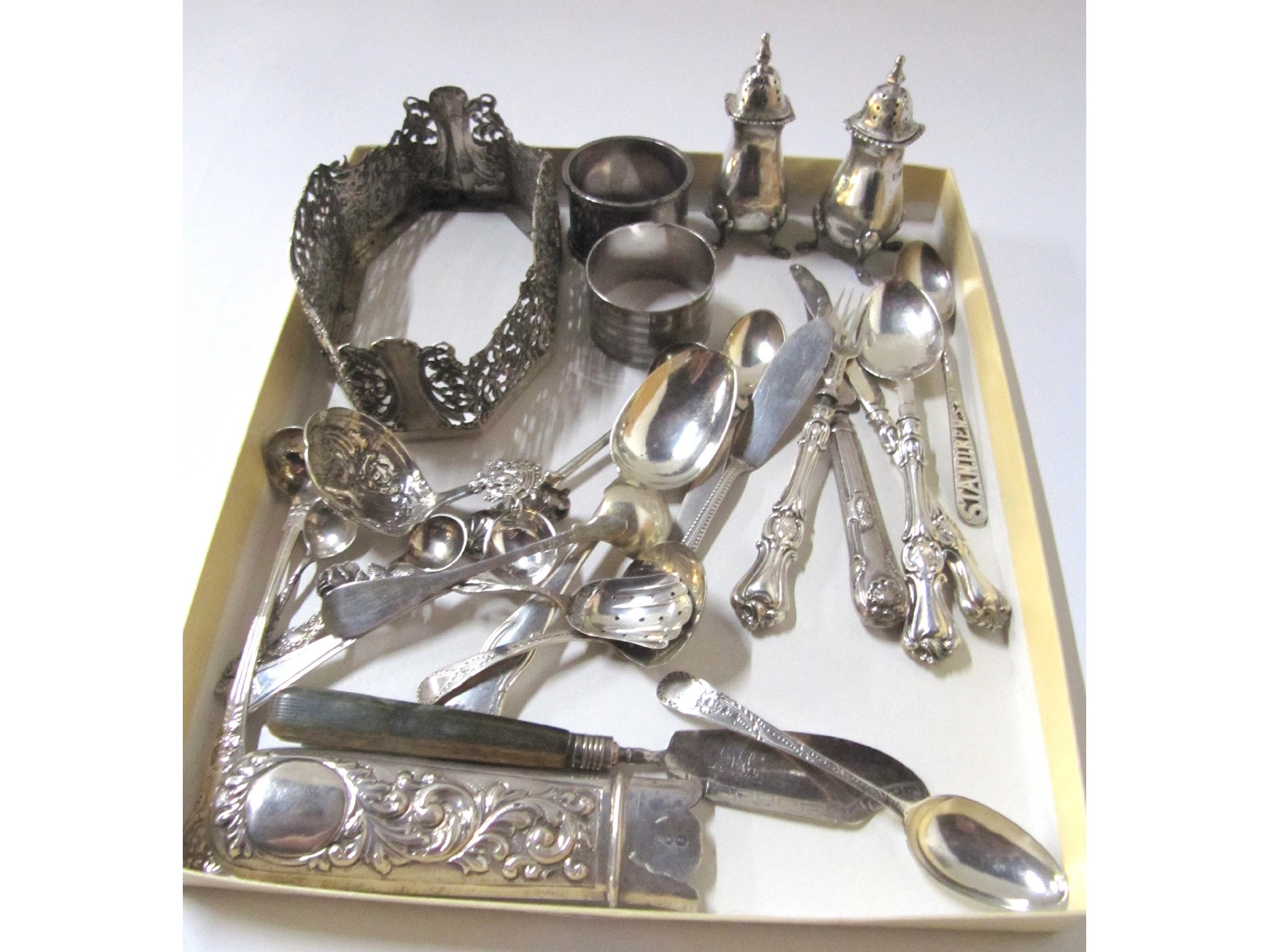 Appraisal: A lot comprising two silver napkin rings two silver peppers