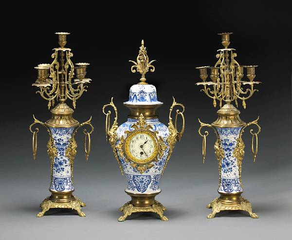 Appraisal: A Baroque style Delft pottery brass mounted three piece clock