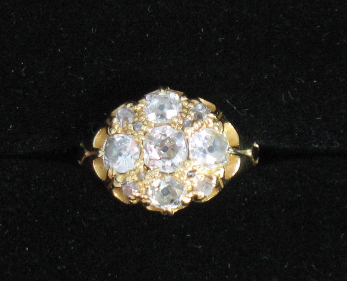 Appraisal: A DIAMOND CLUSTER RING the central round old-cut diamond surrounded