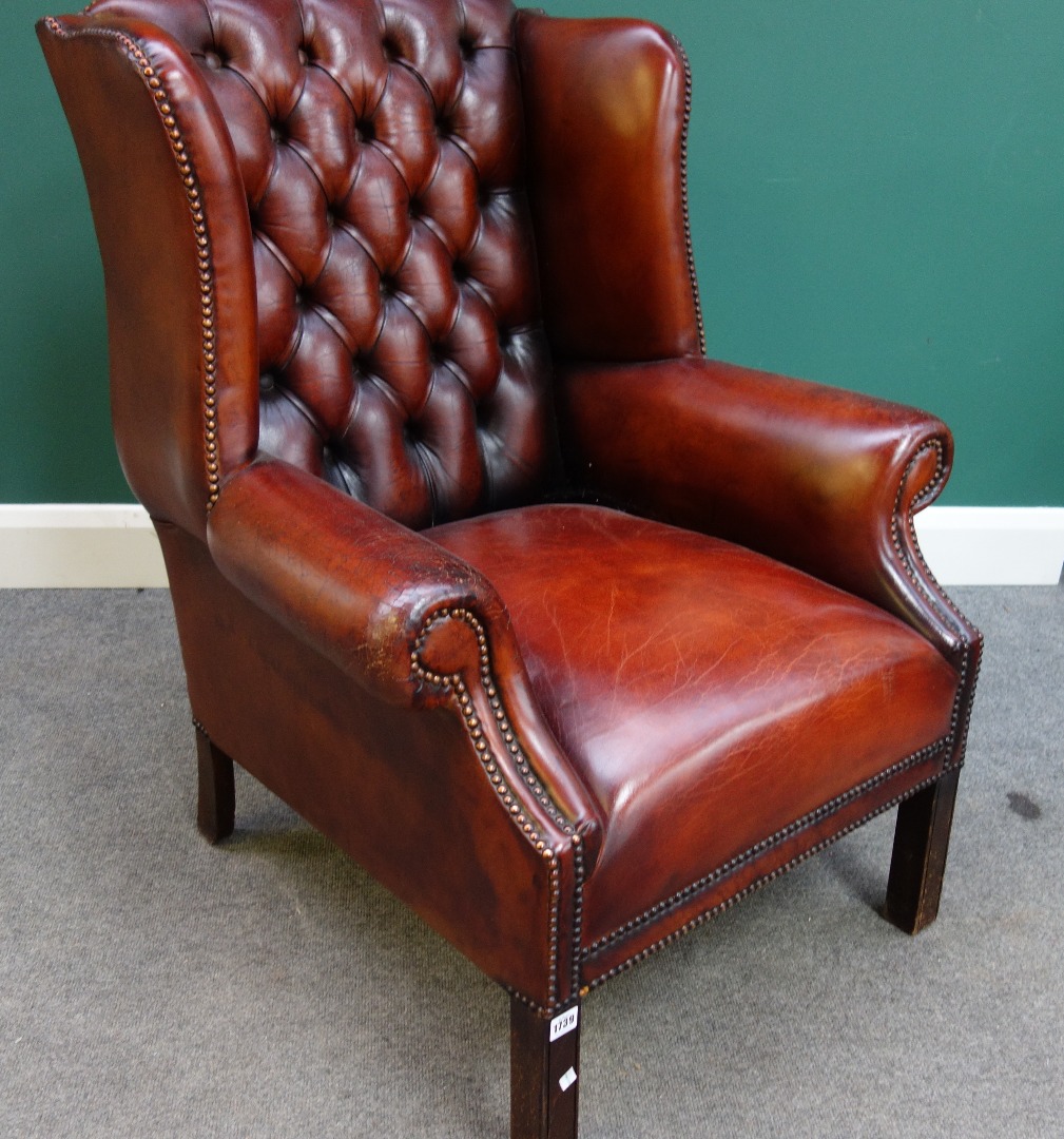 Appraisal: An early th century style studded brown leather upholstered wing