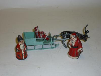 Appraisal: Various metal figures Santa in his sleigh with reindeer long