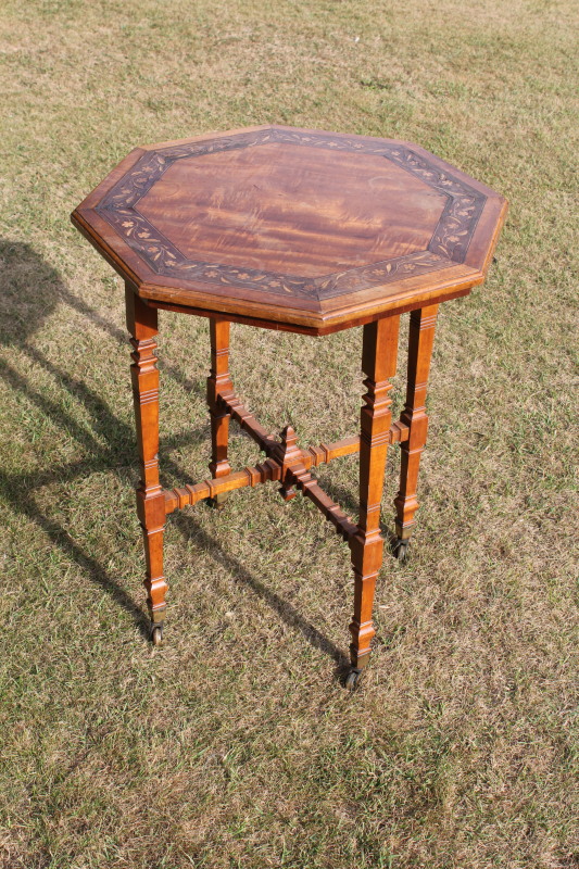 Appraisal: An Edwardian satinwood occasional table with floral marquetry banded octagonal