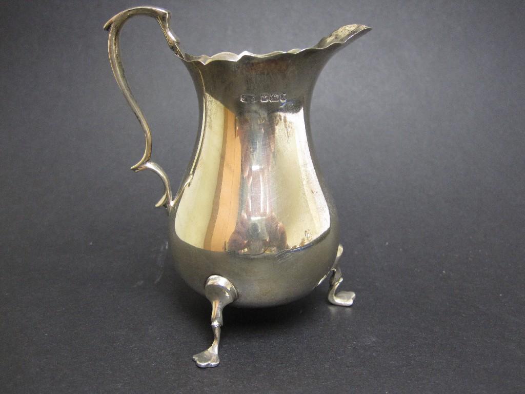 Appraisal: An Edward VII baluster Cream Jug on shaped feet Sheffield