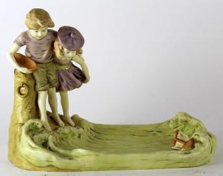 Appraisal: Porcelain statue depicting boy and girl with boat h x