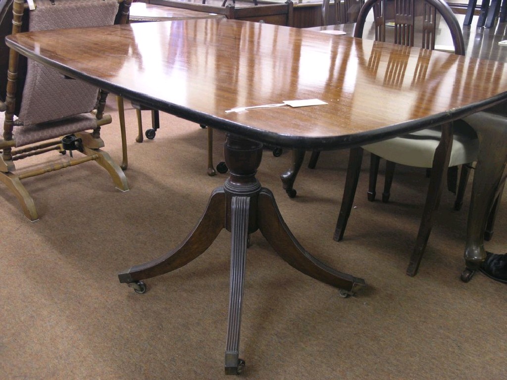 Appraisal: A reproduction mahogany breakfast table rectangular top tilting on pedestal