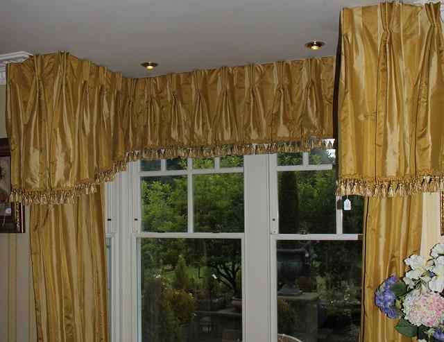 Appraisal: TWO YELLOW SILK CURTAINS AND PELMET