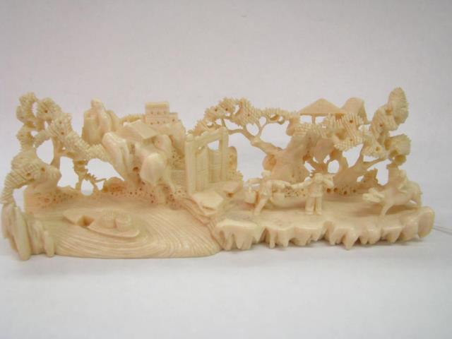 Appraisal: An Oriental reticulated carving of ivory depicting figures and scenic