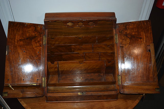 Appraisal: Victorian walnut stationery cabinetwith folding doors enclosing a fitted interior