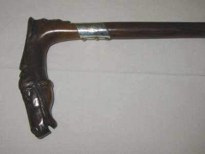 Appraisal: A WALKING STICK the fruit wood grip carved as a