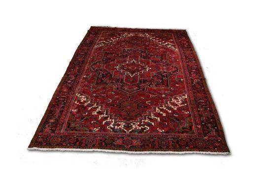 Appraisal: ORIENTAL RUG Room size Heriz Dark blue border and red