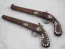 Appraisal: Two Middle Eastern percussion cap pistols with damascened barrels m