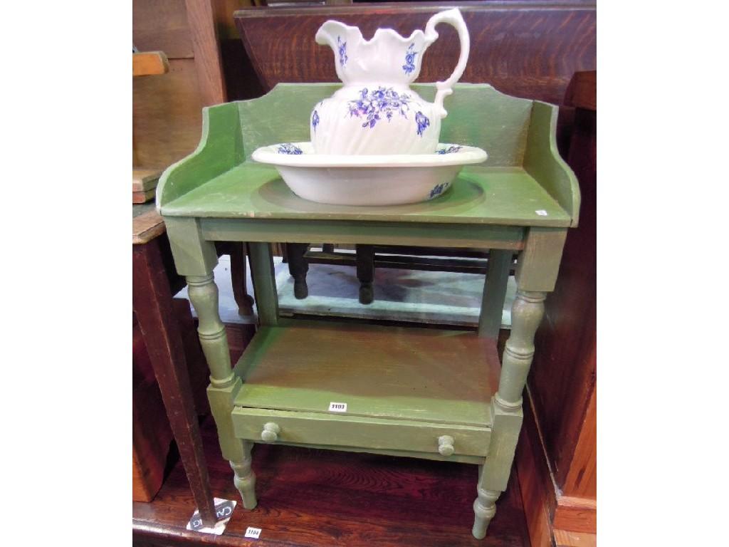 Appraisal: A painted pine two tier washstand fitted with a frieze