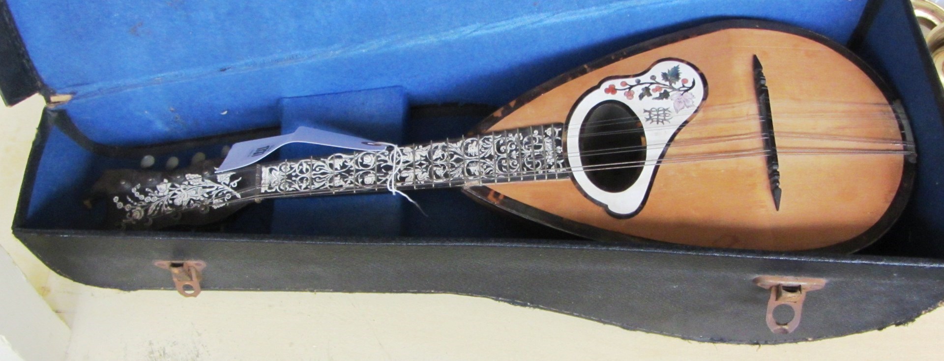 Appraisal: A continental mandolin with carved bone and ivory inlaid decoration