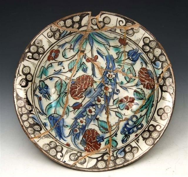 Appraisal: AN IZNIK POTTERY DISH circa decorated with tulips and chrysanthemums