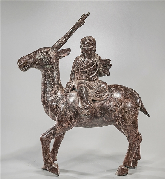 Appraisal: Chinese bronze sculpture of child sitting on a deer mark