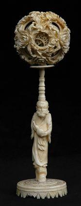 Appraisal: CHINESE CARVED IVORY PUZZLE BALL ON STAND The pierced flower-carved