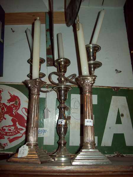 Appraisal: A PAIR OF SHEFFIELD CANDLESTICKS AND A THREE BRANCH CANDLESTICK