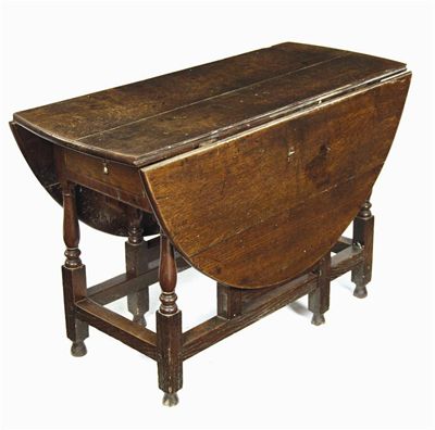 Appraisal: An th century oak gateleg table with an oval drop-leaf