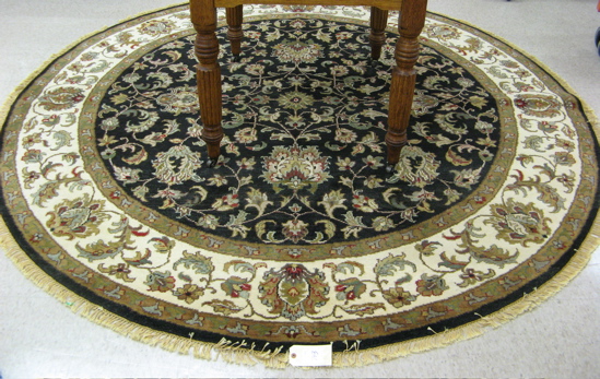 Appraisal: A ROUND ORIENTAL CARPET Persian Kashan design overall floral type