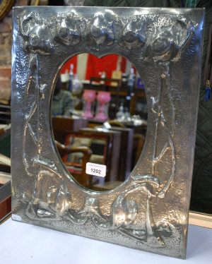 Appraisal: An Arts Crafts period hammered pewter mirror with raised tulip