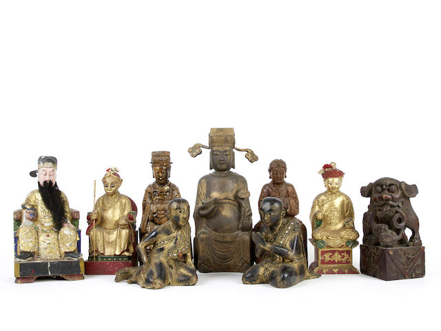 Appraisal: Nine various wood sculptures Including one seated deity with nodding