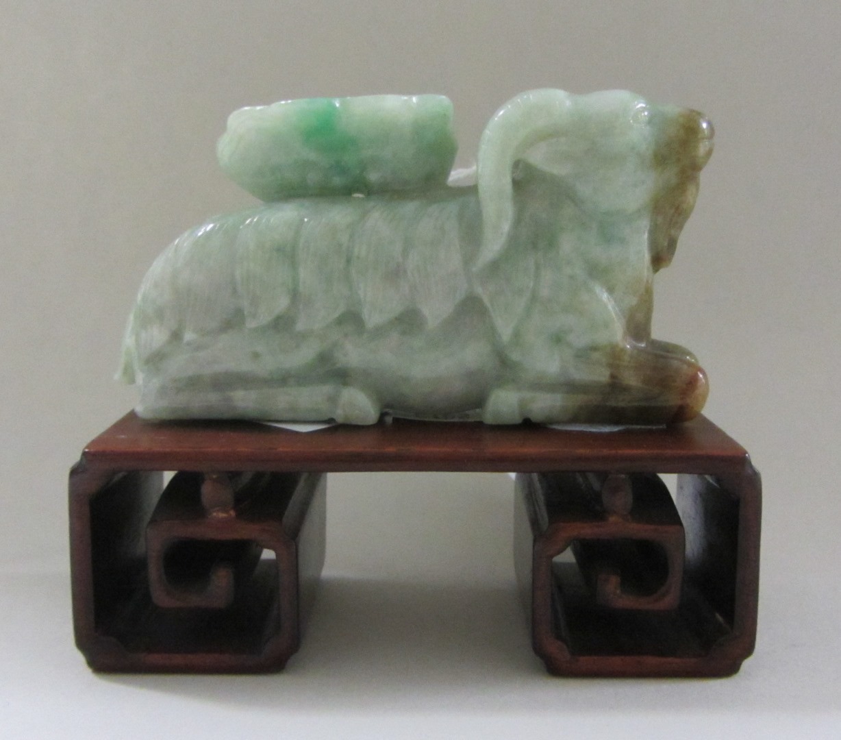 Appraisal: A Chinese jadeite group th century carved as a recumbent