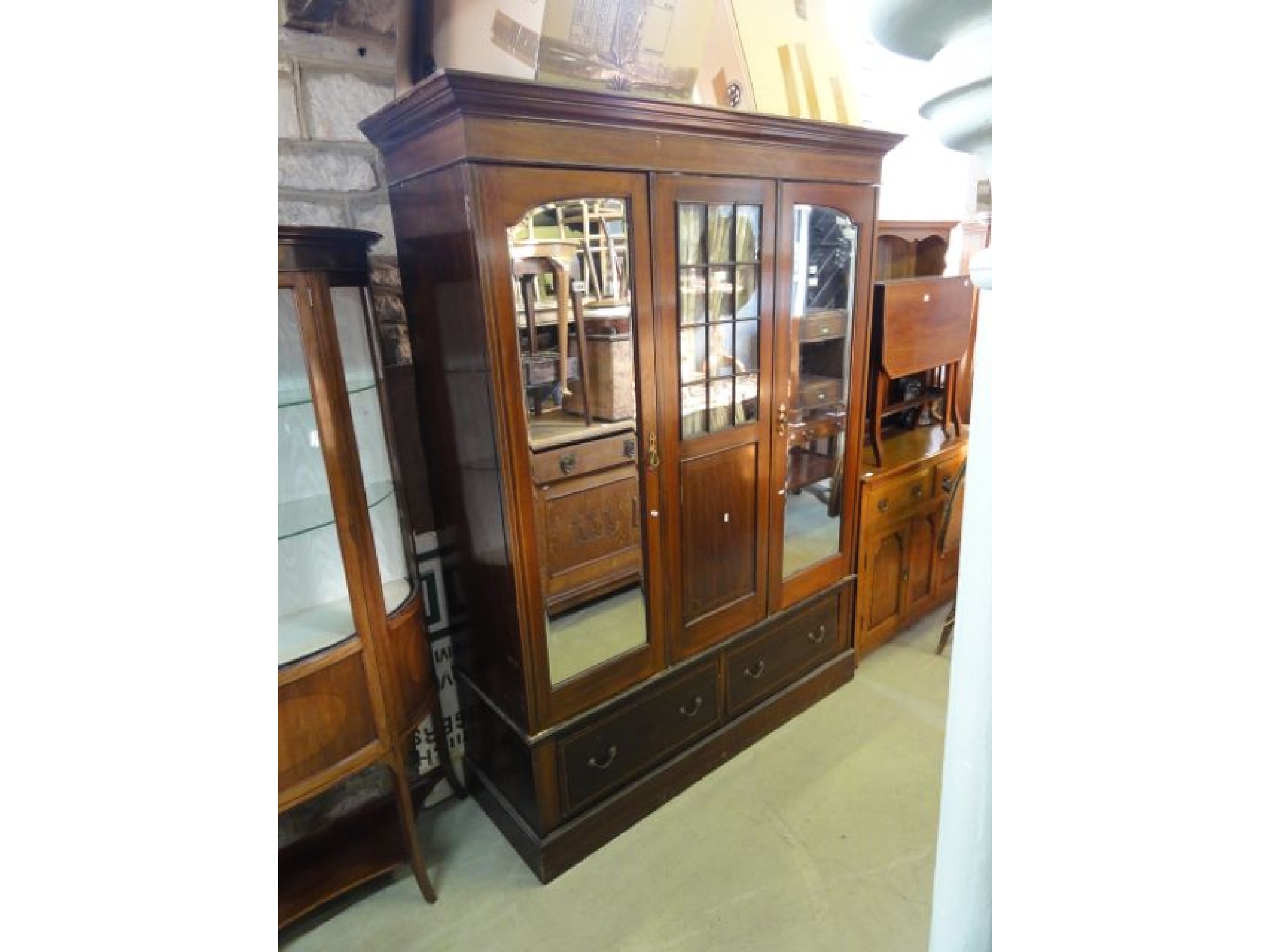 Appraisal: An inlaid Edwardian mahogany wardrobe with moulded cornice over a