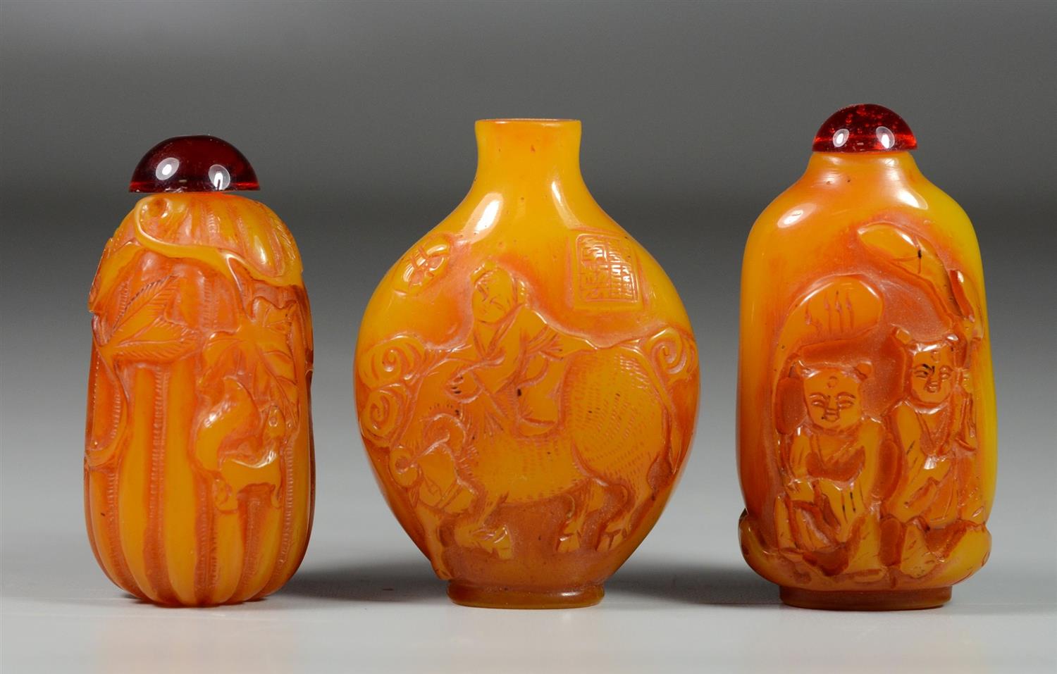 Appraisal: Carved Peking glass amber Chinese snuff bottles horses figures floral