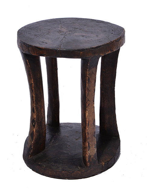 Appraisal: A SOUTH AFRICAN SIMPLE WOODEN STOOL on four naive cut