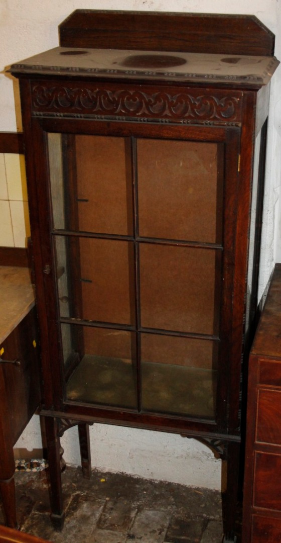 Appraisal: An early thC oak display cabinet of shaped outline with