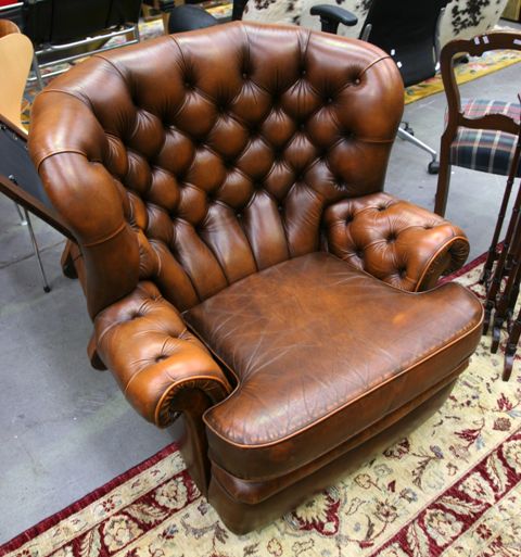 Appraisal: An English Chesterfield tan leather wingback armchair