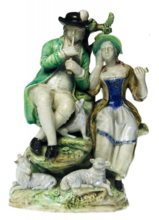 Appraisal: A STAFFORDSHIRE PEARLWARE GROUP OF A SHEPHERD AND SHEPHERDESS ON